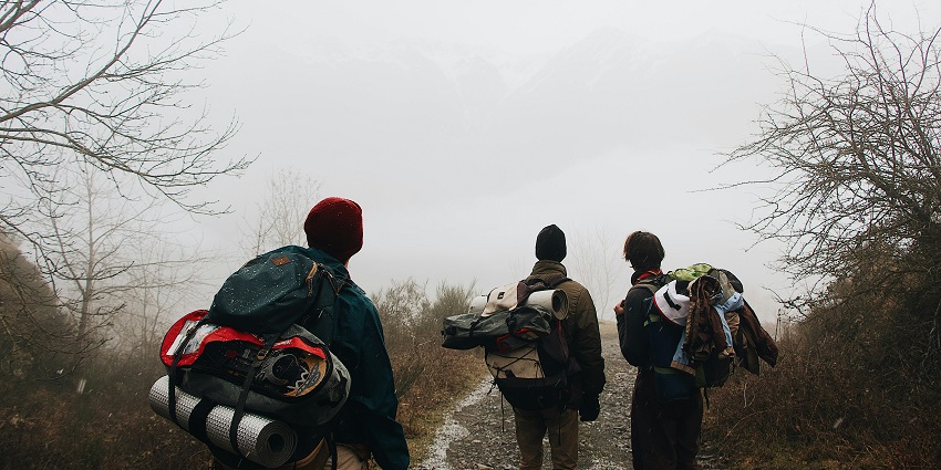 An image of trekkers, trekking near Coimbatore with clear skies and scenic mountain views.