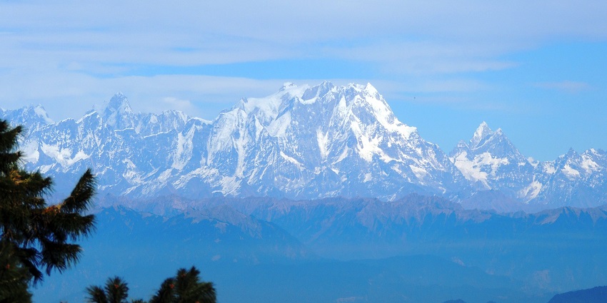 Visual of a snow-capped mountain from the Gangotri Temple in winter season