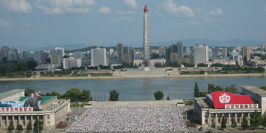 A large crowd of people in white shirts gathered in Kim Il Sung Square, Pyongyang