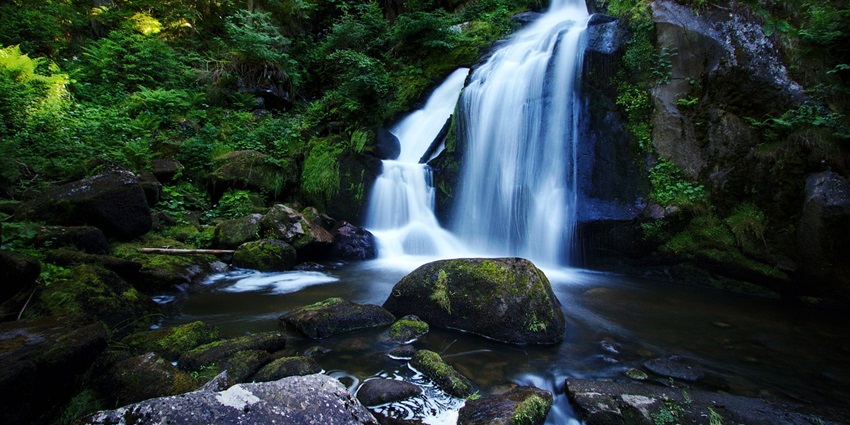 An image of a waterfall that resembles Triberg Waterfalls, a famous attraction in Germany