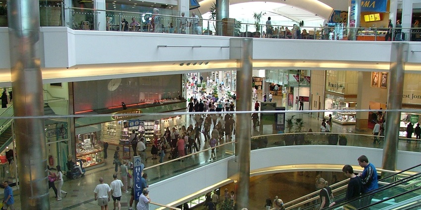Image of inside view of Vellore Mall with various shops and people roaming with their families and friends