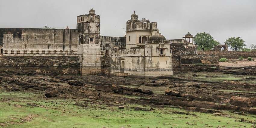 An image of Chittorgarh Fort with ancient stone walls, towers, in an overcast weather