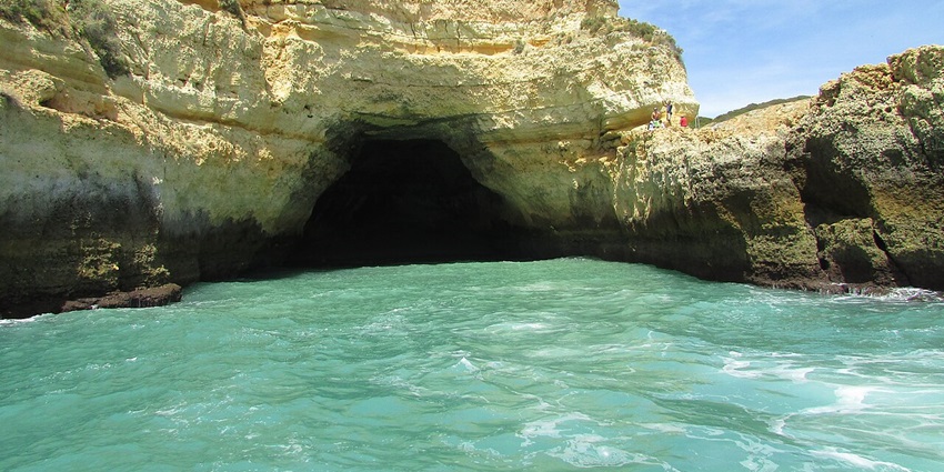 Golden cliffs and turquoise waters await at Benagil Caves in Portugal