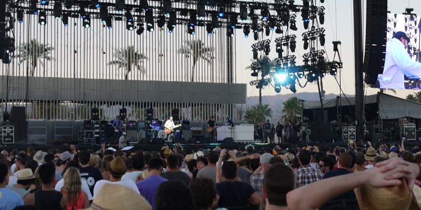 An image of festival-goers basking in the sunshine and warmth of an April day at Coachella