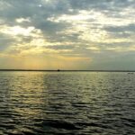 A stunning image of the Biggest Lake in India reflecting the golden hues of sunrise.