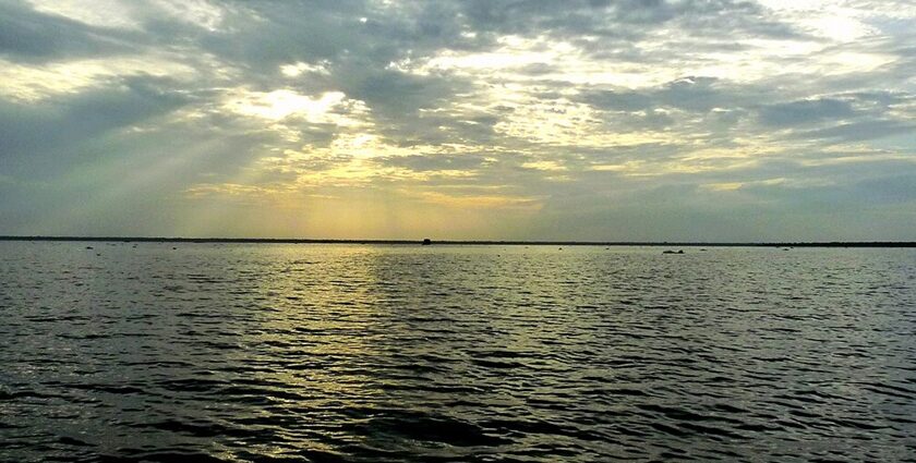 A stunning image of the Biggest Lake in India reflecting the golden hues of sunrise.