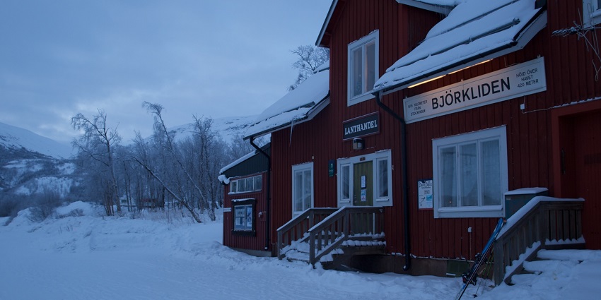 An image showing Sweden's scenic Björkliden Railway Station, surrounded by mountains