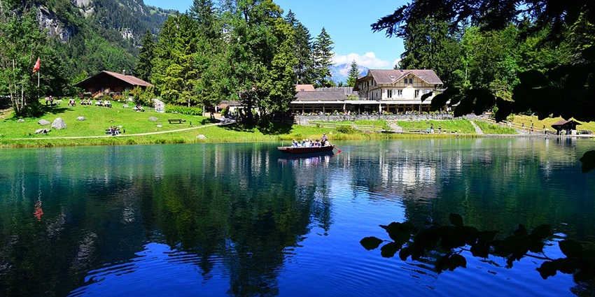 An image view of Blauser in Switzerland with crystal-clear blue waters, dense forest