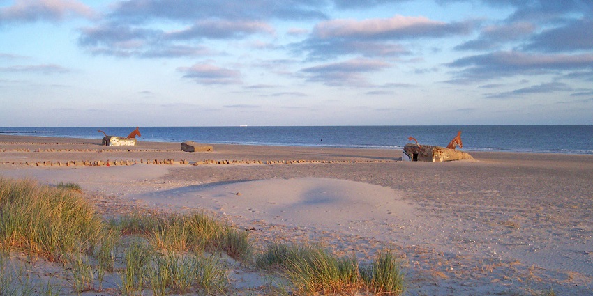 An image of Blåvand Beach in Denmark surrounded by bunkers featuring the beautiful location.
