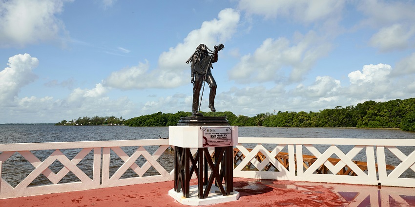 An image of a statue of the legendary Jamaican singer Bob Marley holding his Guitar.