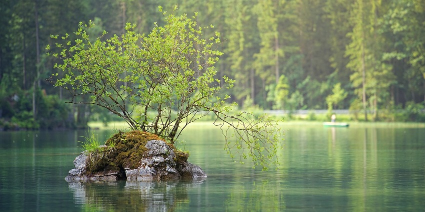 An image of Brahmala Lake with surrounding hills and greenery.
