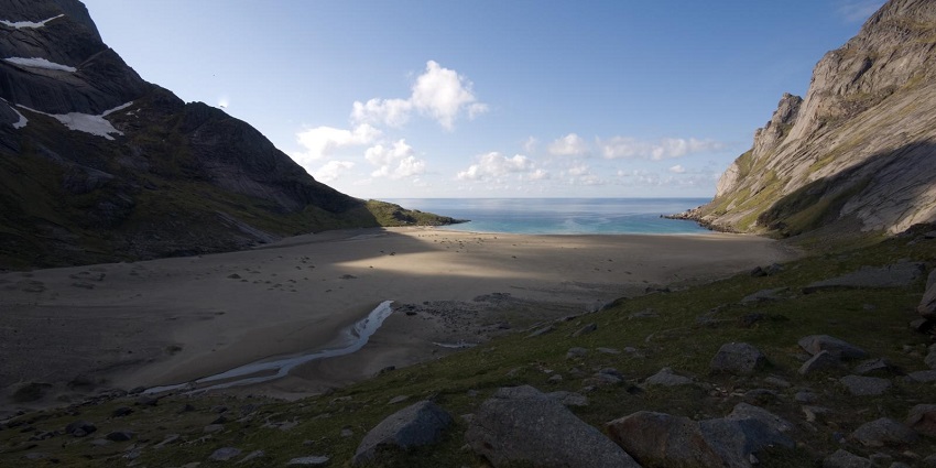 An Image of Bunes Beach, with mountain cliffs in the background. One of the most stunning beaches in Norway.