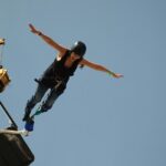 Snapshot of a woman bungee jumping from a platform–Bungee Jumping In Vizag