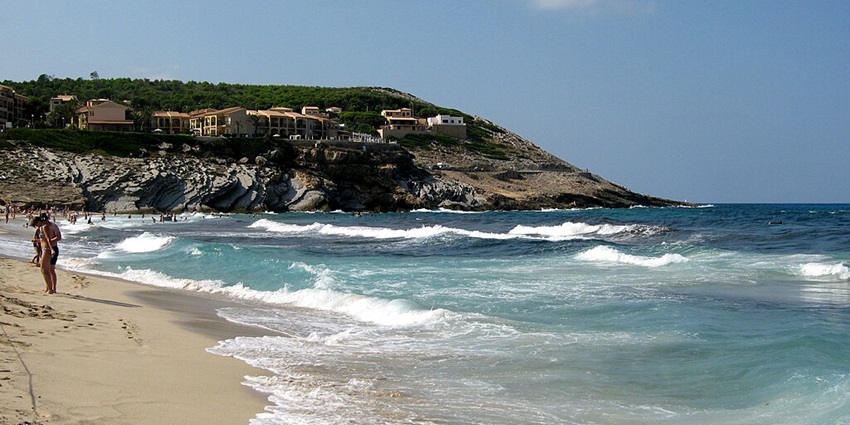 Image of tranquil waters at Cala Mesquida in Spain and slow beach water waves