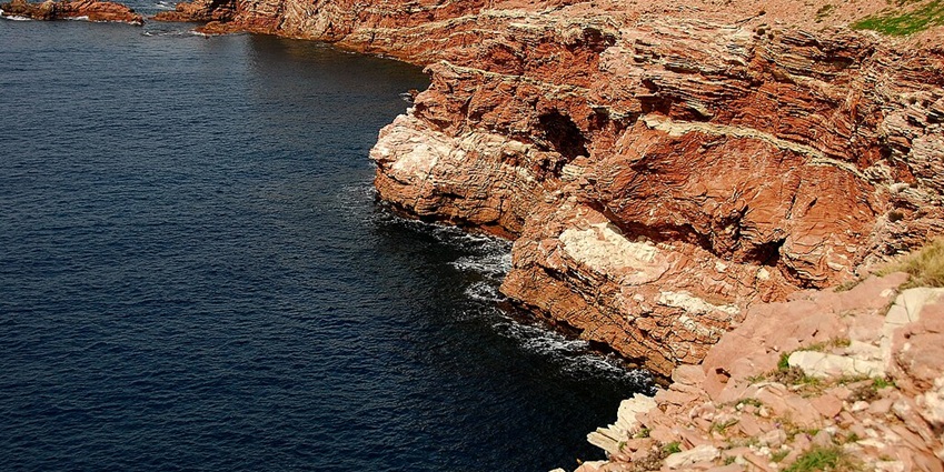 Turquoise waters and rugged cliffs at Cala Rossa, Favignana, Sicily