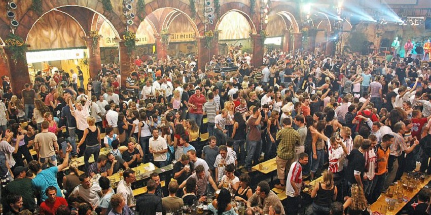An image of people enjoying beer at the Cannstatter Volksfest in Stuttgart, Germany.