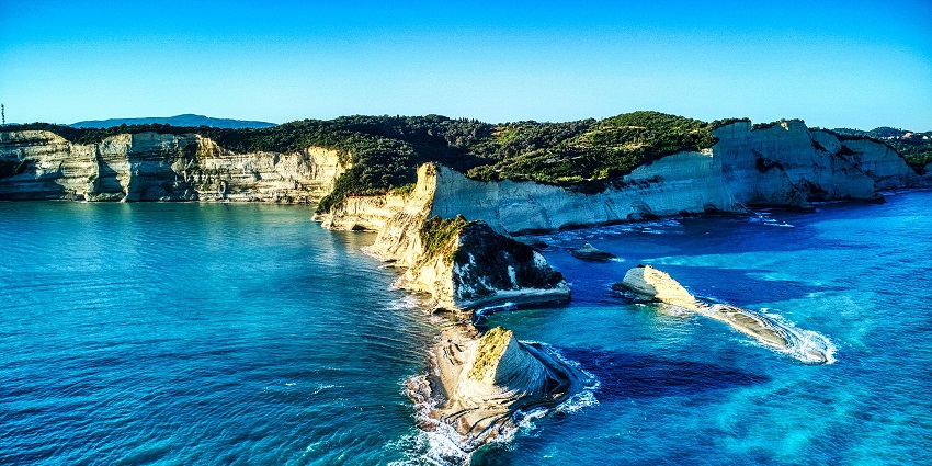 Image of picturesque Cape Drastis view with clear blue water and huge rocks