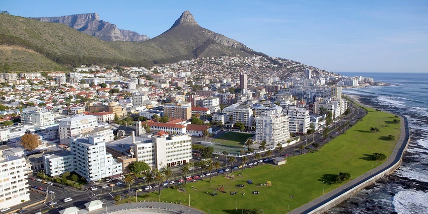 Aerial view of Sea Point in Cape Town, showing the sea, white buildings and mountains behind them