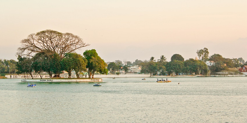A stunning photograph of people boating at Ulsoor Lake in the evening during sunset