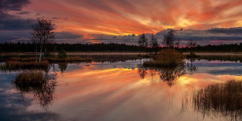 Image of a serene sunrise over a water body similar to one in Agbokim Waterfalls Nigeria