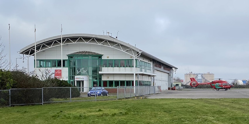 A glimpse of the Cardiff Heliport featuring manicured runways and lush greenery.