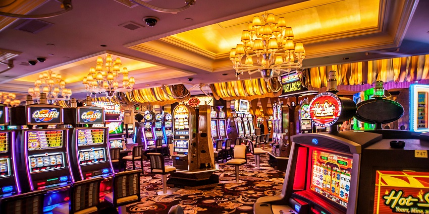 A vibrant casino with slot machines and elegant chandeliers similar to Casino Helsinki