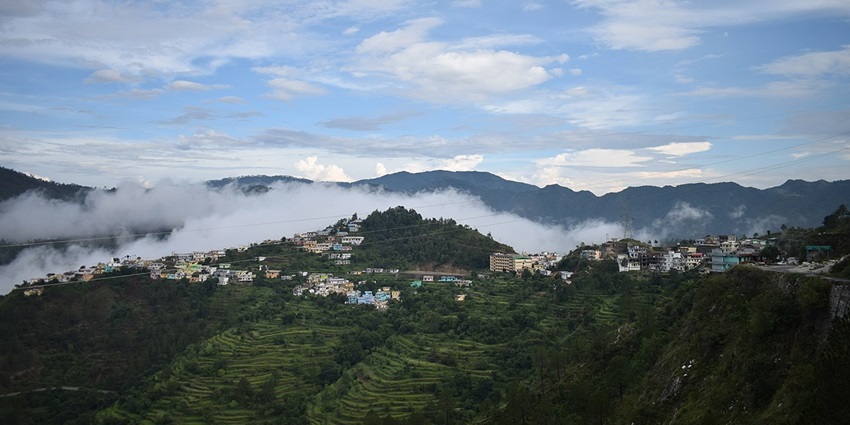 An image showing Chamba as viewed from ITI, featuring pretty hills, dense greenery, and a peaceful vibe