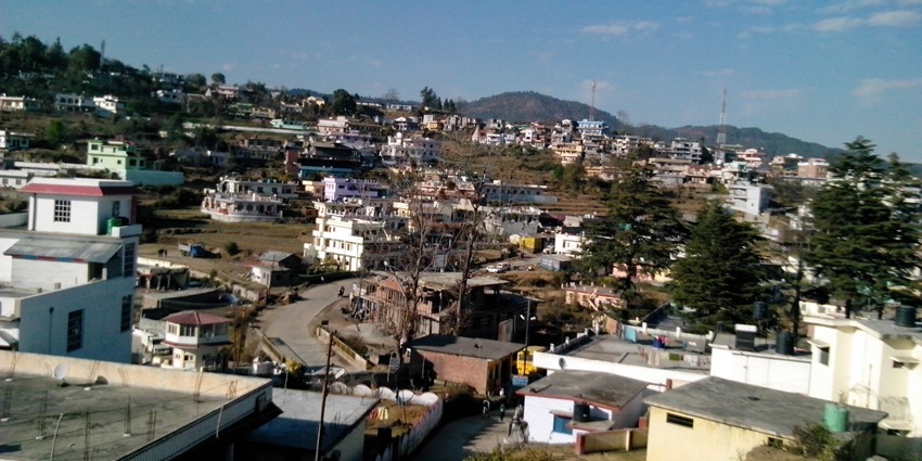 Panoramic view of Champawat town with hills, buildings, and green landscape--places to visit in lohaghat