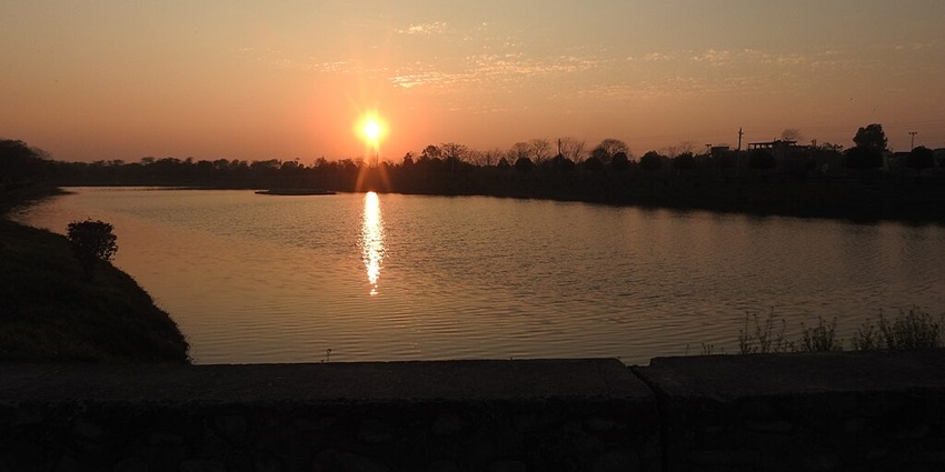 A picturesque image of a sunset’s reflection over a lake