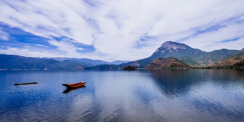 One of the lake with small pieces of land in the middle of the lake surrounded by greenery.