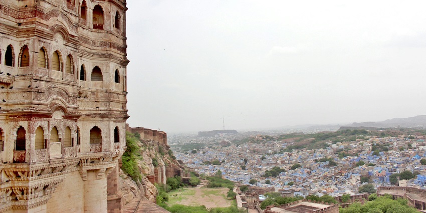 A picture of Chilkigarh Raj Palace with its intricate architecture and nearby Kanak Durga Temple.