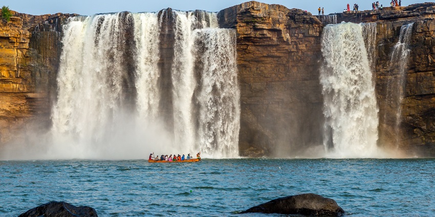 An image showing Chitrakote Falls in India with water cascading over a wide rock formation