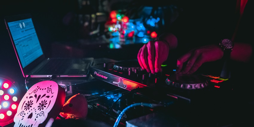 An image of a DJ controlling his console to setup vibe similar to Kyrgyzstan Nightlife