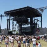 An image of a vibrant scene of the Coachella Music Festival, with a crowd enjoying live performances