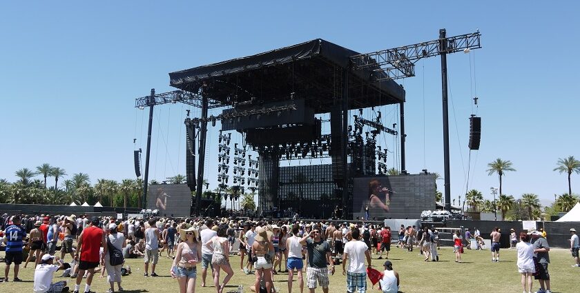 An image of a vibrant scene of the Coachella Music Festival, with a crowd enjoying live performances