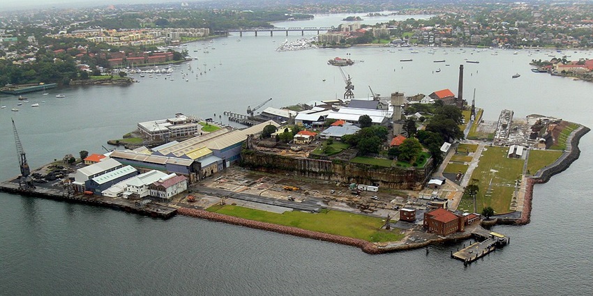An aerial view of Cockatoo Island in Sydney Harbour, showcasing its historic shipyards