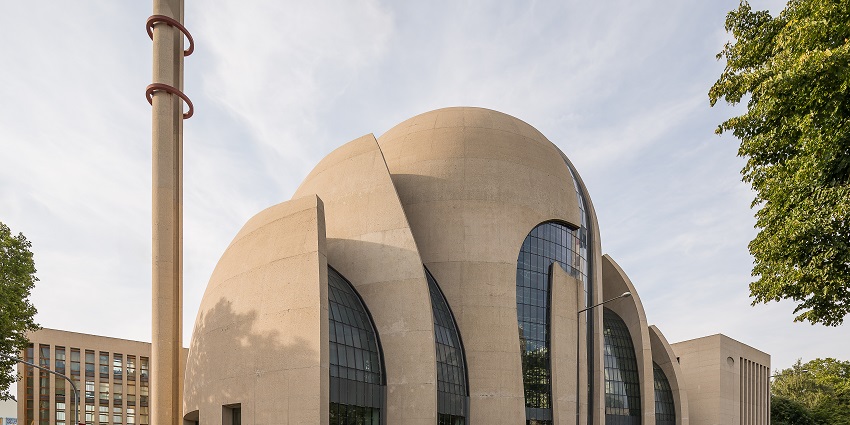 An image of Cologne Central Mosque with its striking modern design and minarets