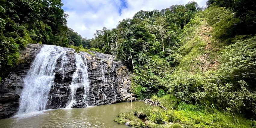 An image of the Abbey Falls in Coorg, offers amazing views of the mist-covered hills.
