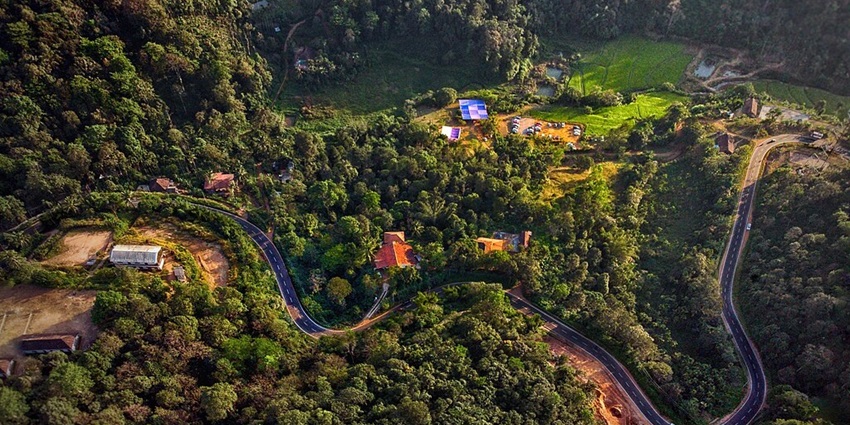 An image showing an aerial view of Coorg, with its landscape and surrounding greenery
