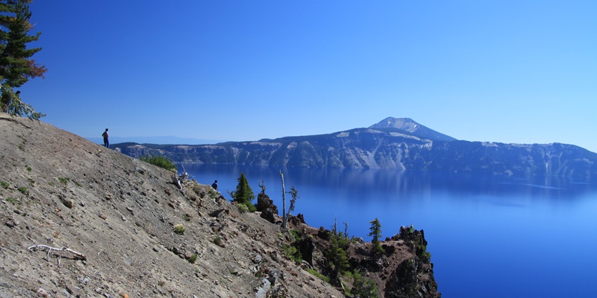 An image of Crater Lake in Oregon, showcasing deep blue waters surrounded by rugged cliffs.