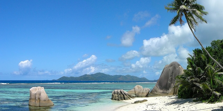 La Digue Island has the perfect atmosphere for cycling with blue skies, tropical trees, and clear waters