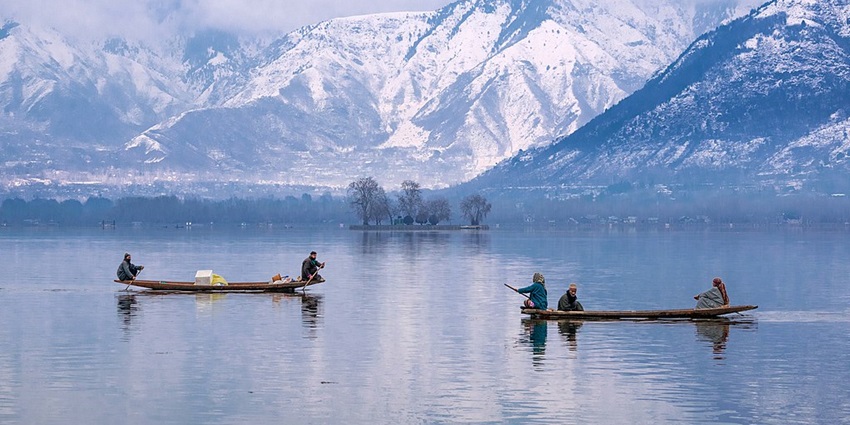 Dal lake with the people sitting on two boats, trees - Famous Lakes In Jammu And Kashmir