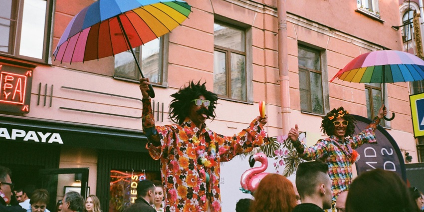 Two men performing on the streets in colourful apparels with local bands.