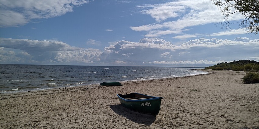 Urban beach along the Daugava River, offering swimming areas, volleyball courts, and family-friendly relaxation.