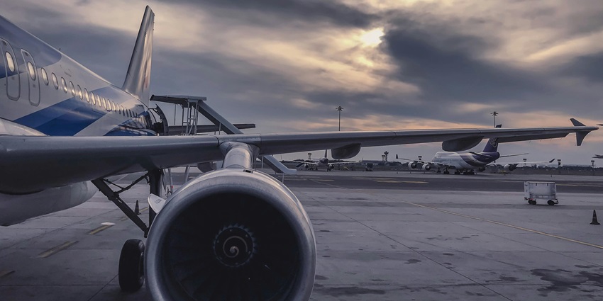 Scenic image of an aeroplane side engine and its airport in the backdrop