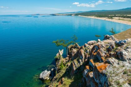 An image of a breathtaking view of one of the deepest lakes in the world, surrounded by stunning natural landscapes