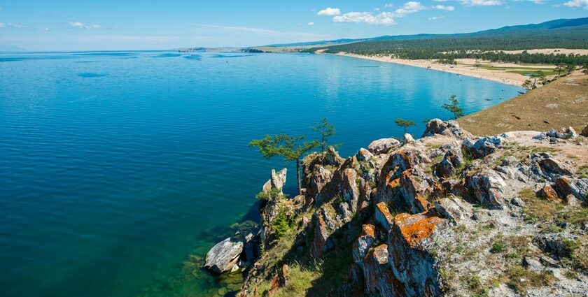 An image of a breathtaking view of one of the deepest lakes in the world, surrounded by stunning natural landscapes