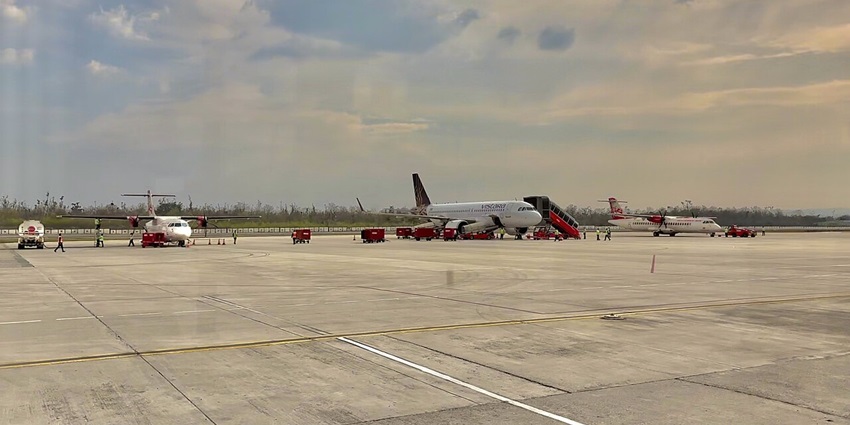 A picture of a couple of aircrafts parked at the vast courtyard of the Dehradun Airport