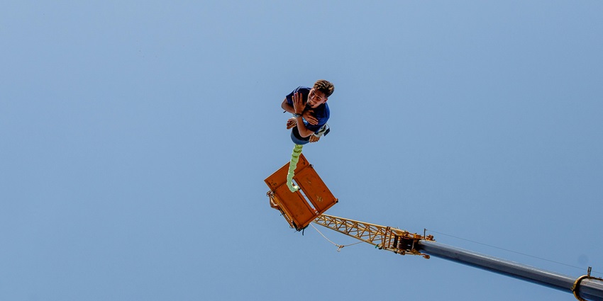 A man bungee jumping from a platform, just like the Bungee jumping set up in Delhi.