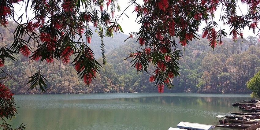 Things to see in Chopta include a high-altitude lake reflecting the majestic Himalayan peaks.